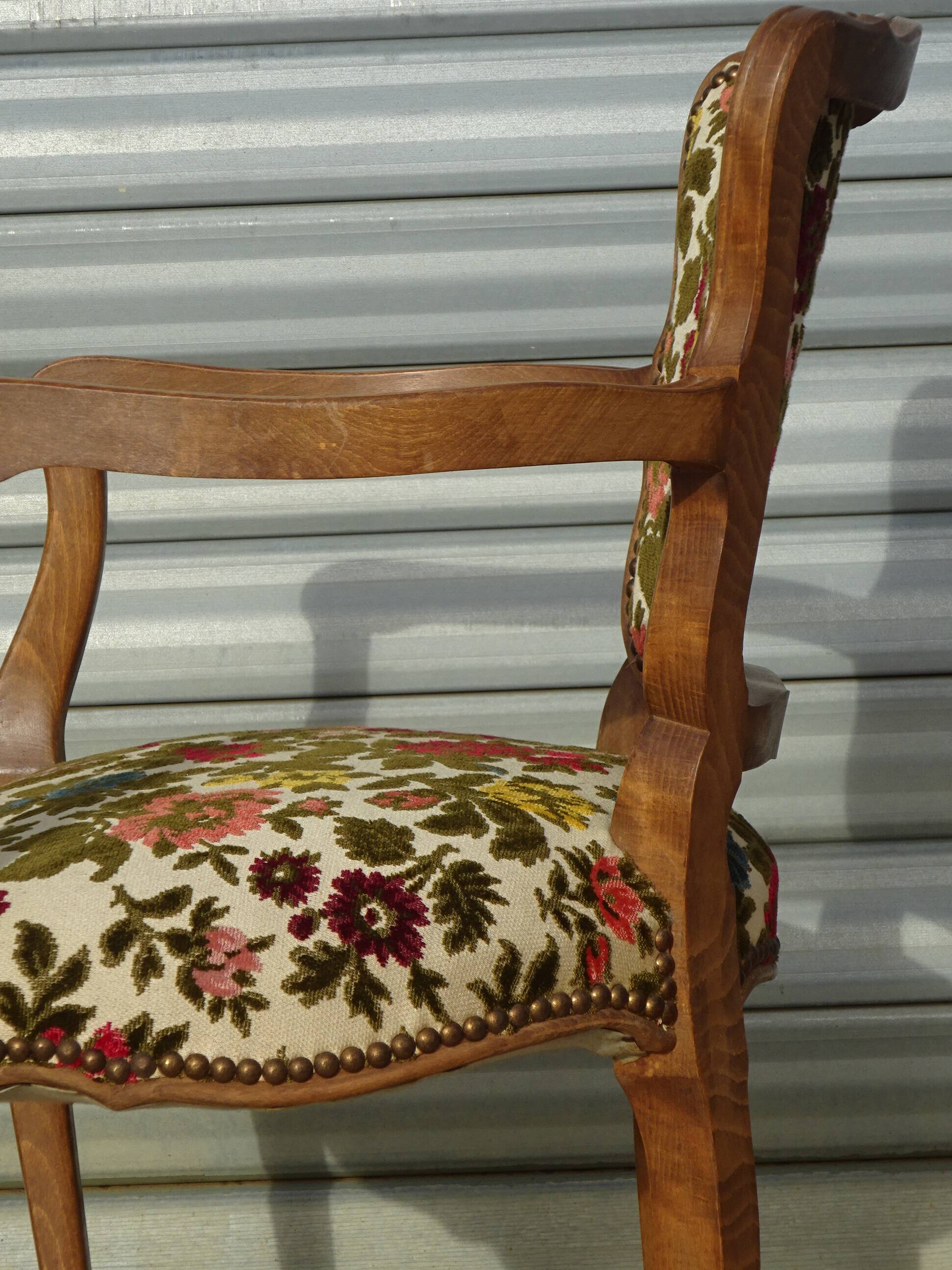 Convertible armchair with brocade fabric and floral patterns.