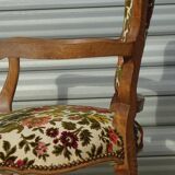 Convertible armchair with brocade fabric and floral patterns.
