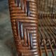 Vintage rattan lounge set, French wicker armchairs and round table, circa 1930–1950.