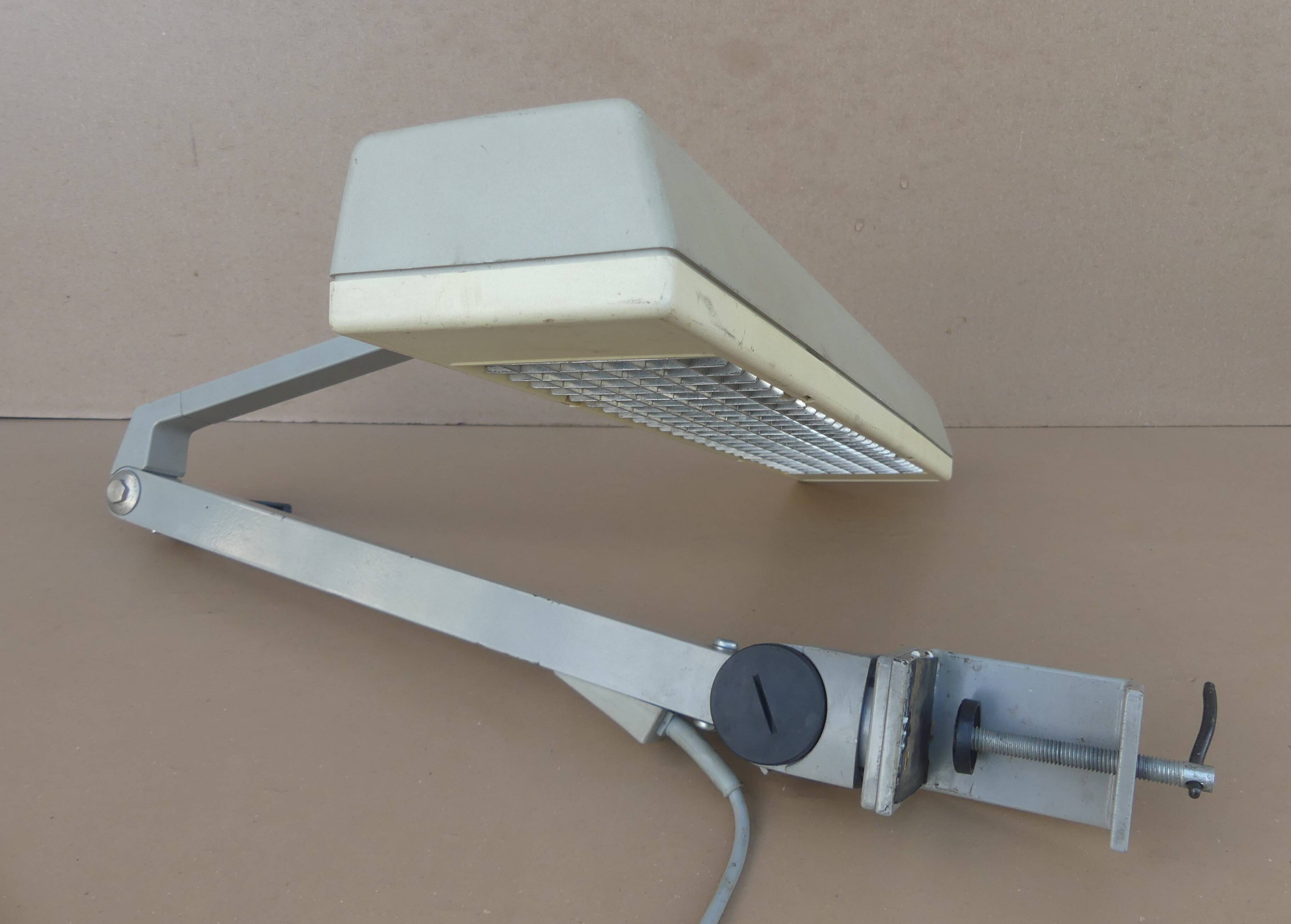 WALDMANN articulated workshop lamp with two industrial clamp arms for architects.