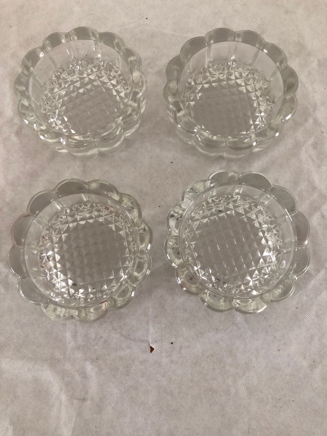 4 flat glass candle holders cut in the shape of Vintage flowers
