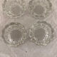 4 flat glass candle holders cut in the shape of Vintage flowers