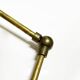 Articulated brass and lacquered iron wall light, 1950s design.