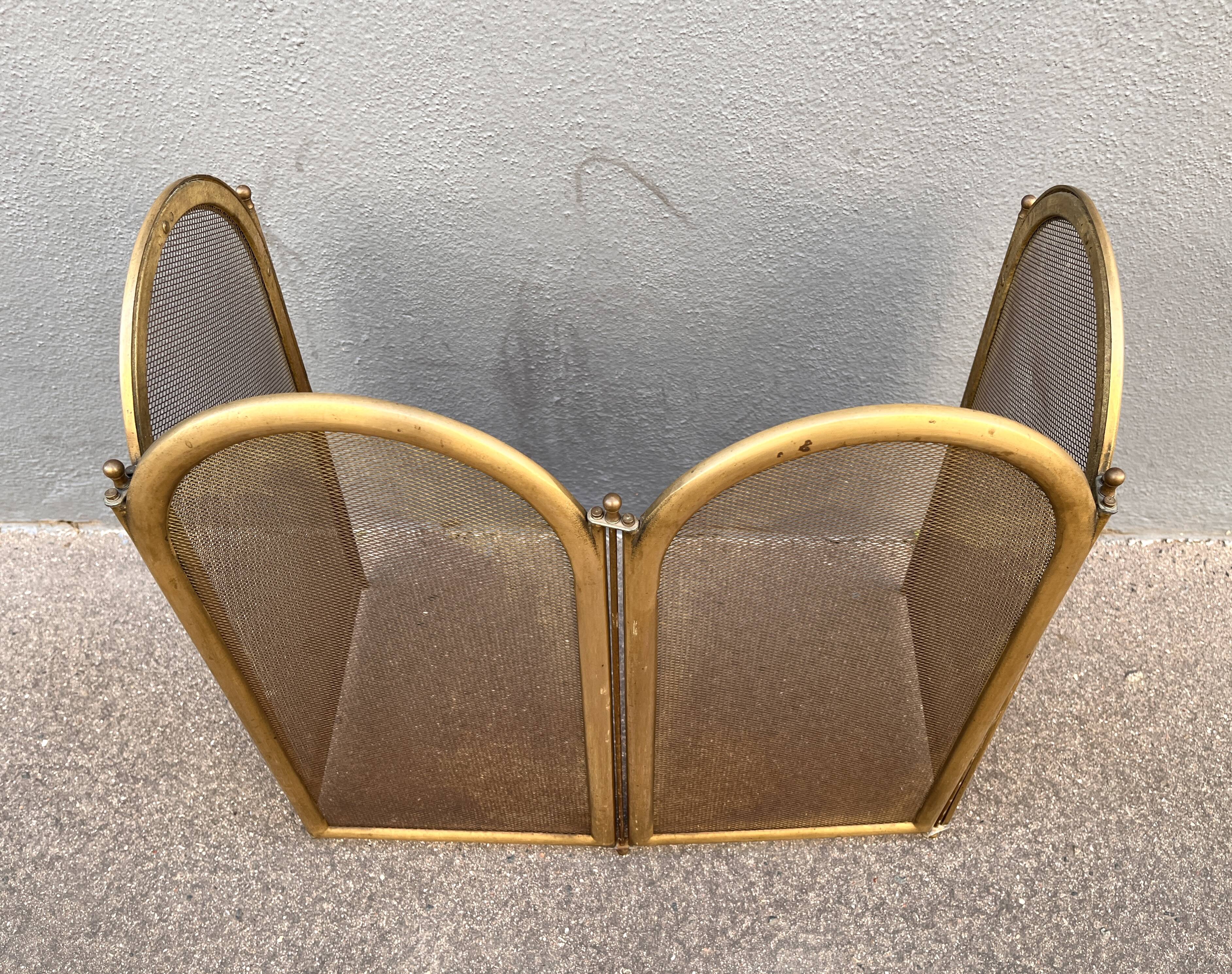 Antique brass fireplace screen from 1920, vintage spark guard.