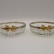 Set of 2 glass and metal bowls with a bow design.