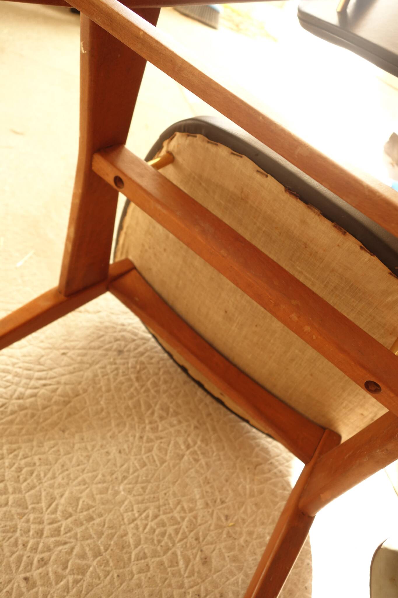 Pair of modernist Scandinavian chairs in teak and black faux leather.