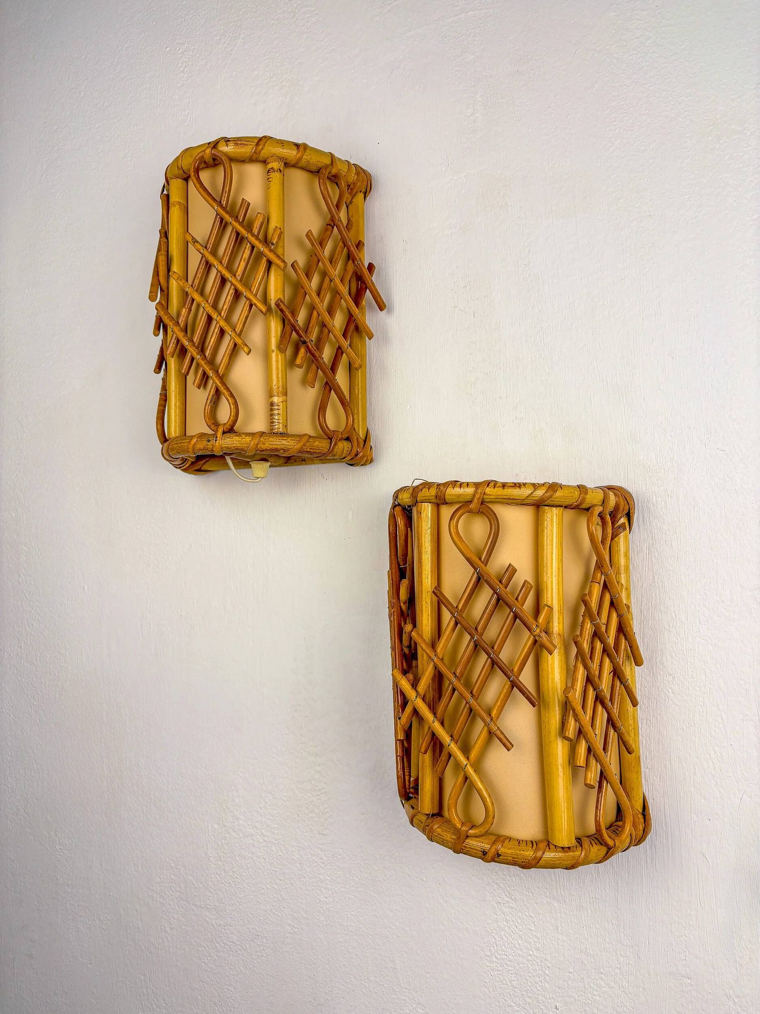 Pair of mid-century rattan wall sconces, circa 1970s, Italy