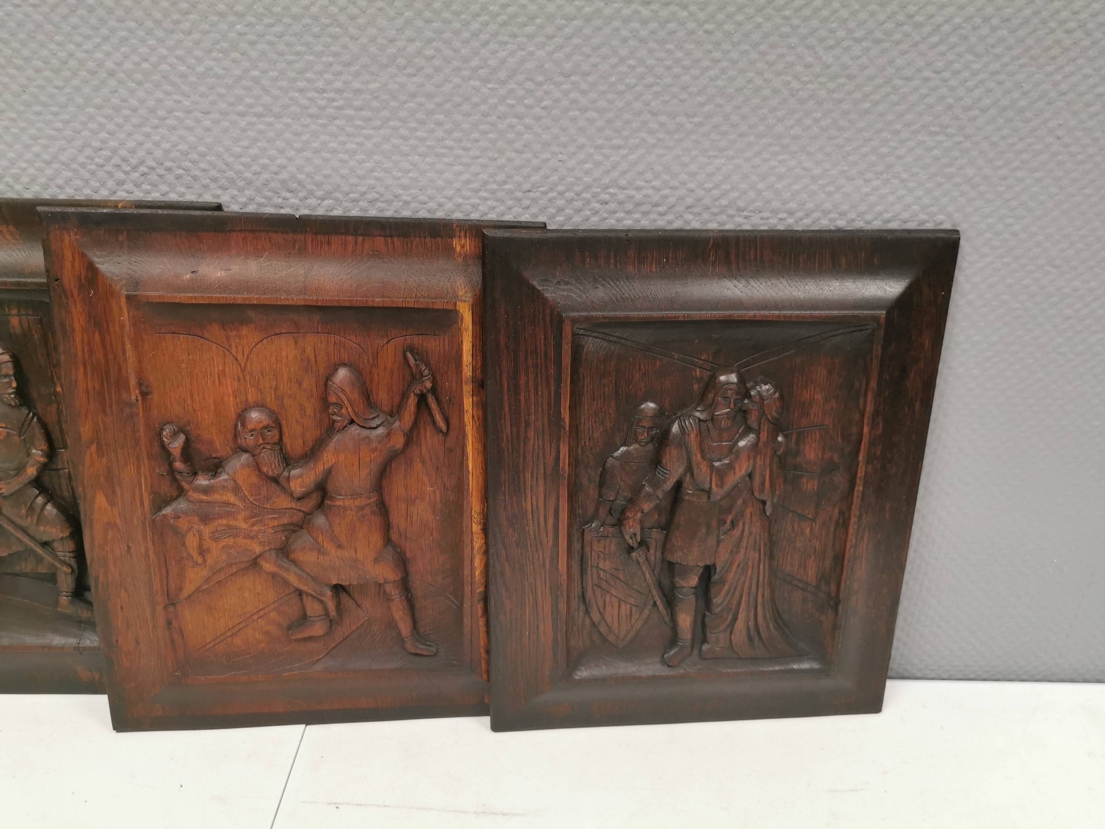Four old wooden carvings to hang on the wall.