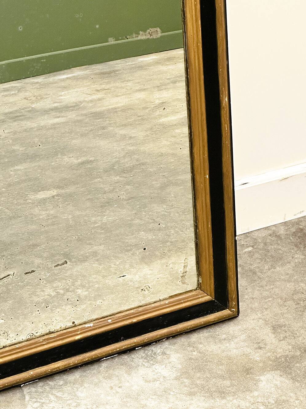 Antique 1800s black and gold mirror with cupid, France 1800s.