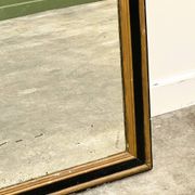 Antique 1800s black and gold mirror with cupid, France 1800s.