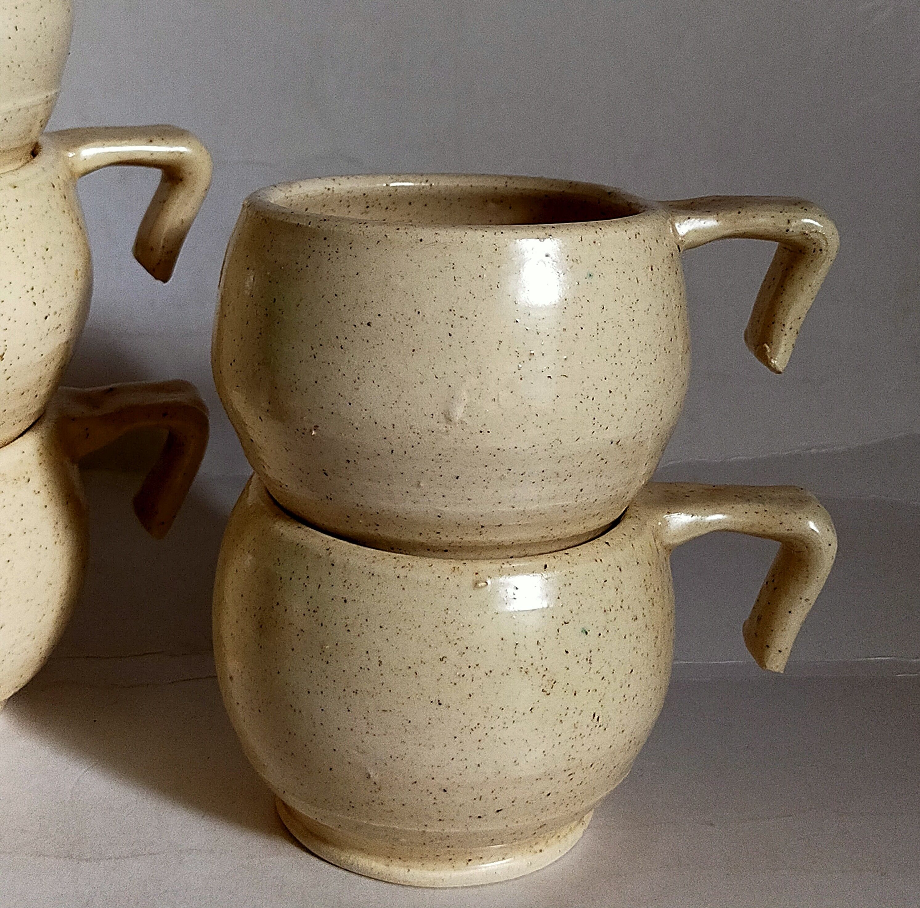 Six vintage potter's ceramic cups with vanilla enamel