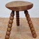 Rustic solid wood tripod stool with turned legs, 45 cm high
