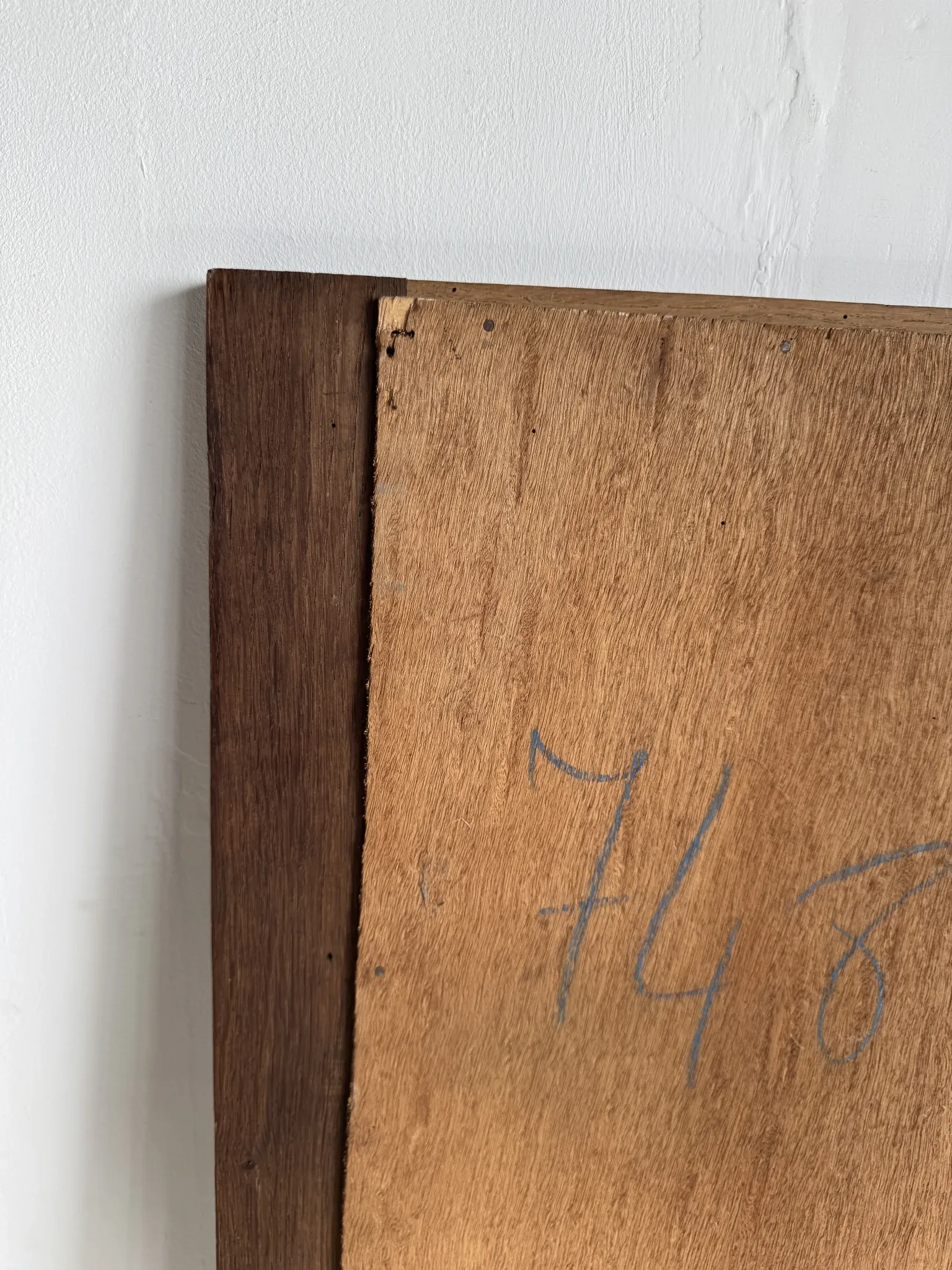Antique mirror door (left) of a brown oak wardrobe with bevelled glass.
