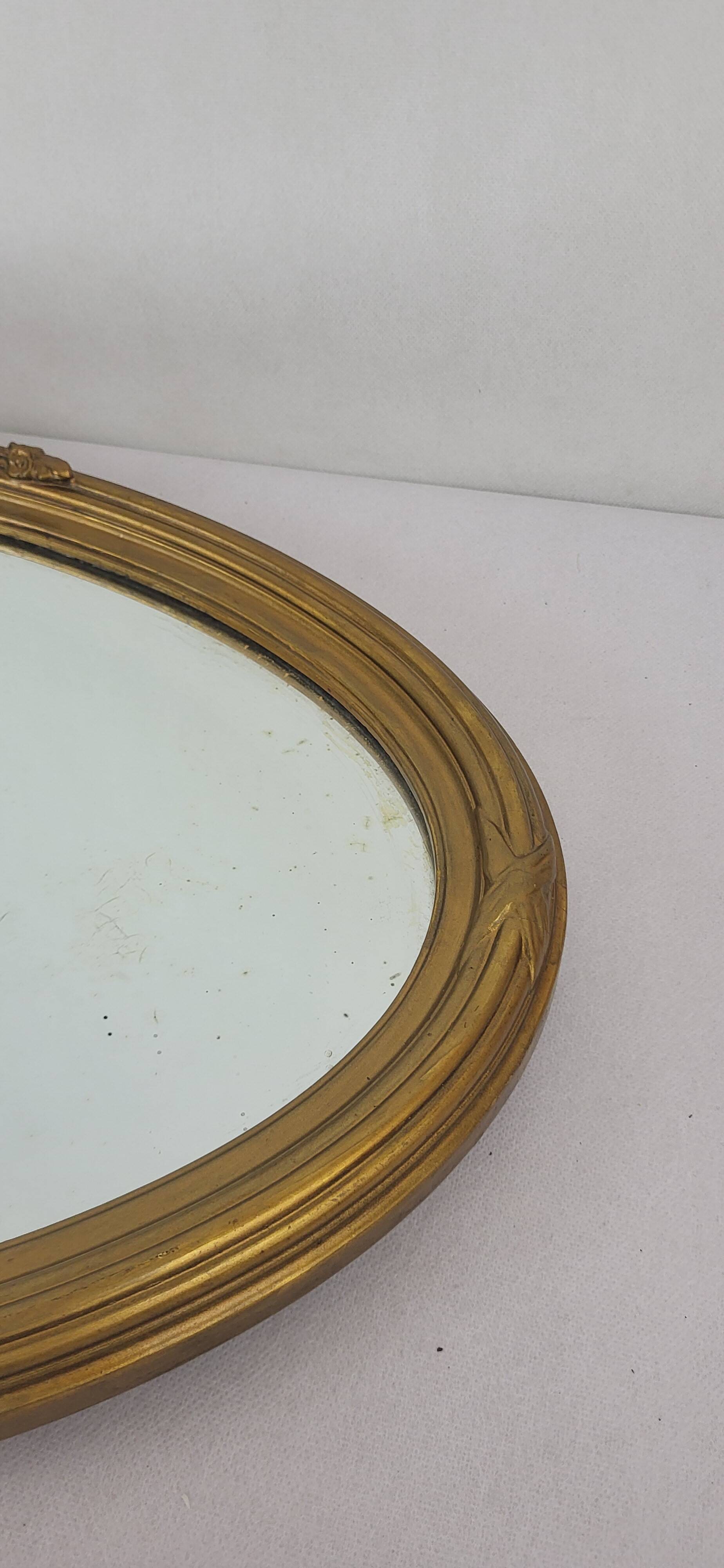 Miroir ovale en bois doré, style Louis XVI