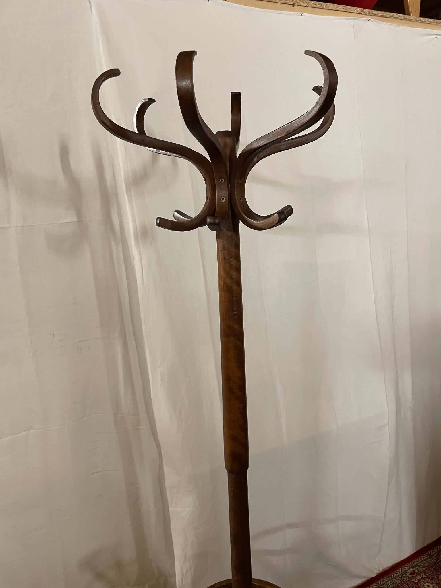 Antique curved wooden coat rack with umbrella stand.