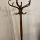 Antique curved wooden coat rack with umbrella stand.
