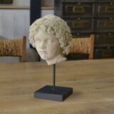 Sculpture of a head in reconstituted stone carved in the antique style of the 19th century