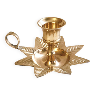 Golden brass hand candle holder decorated with leaves