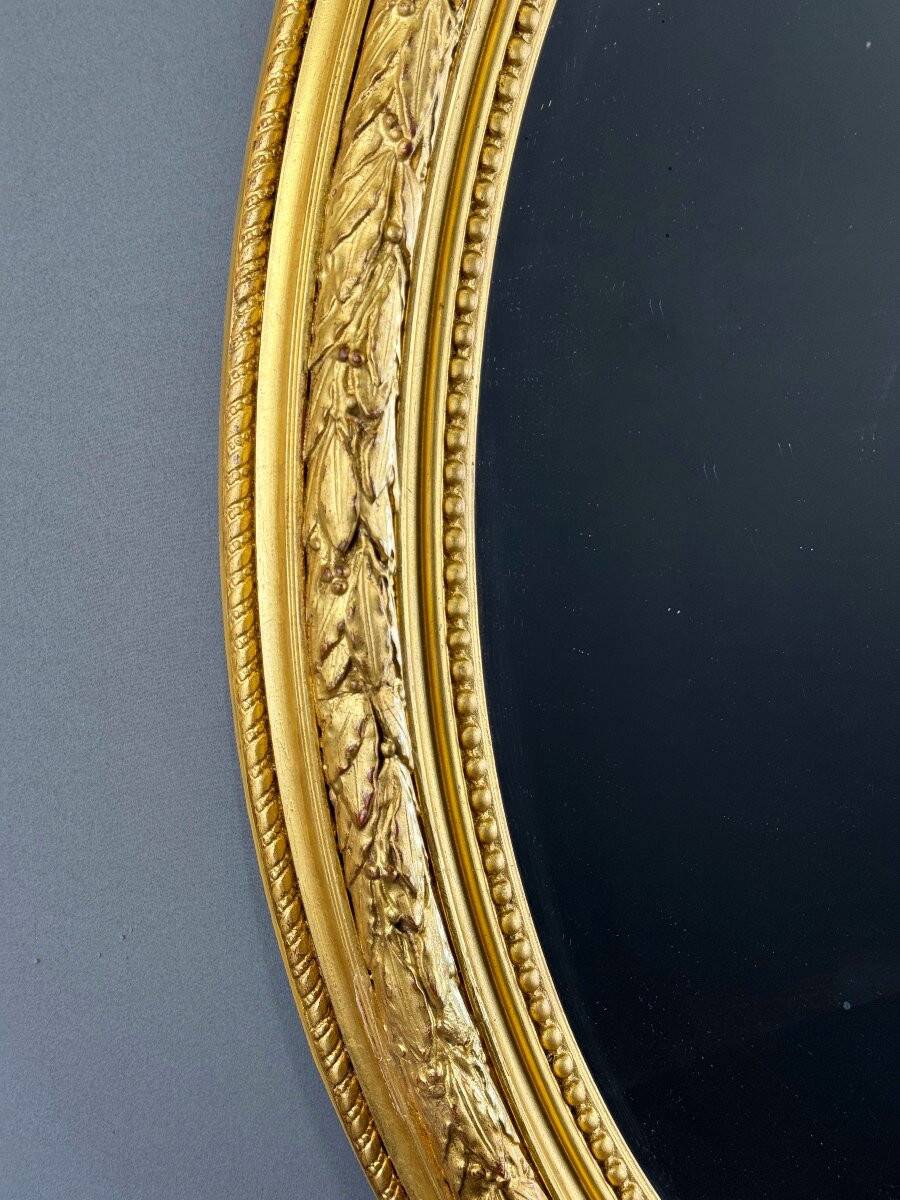 Miroir ovale doré style Louis XVI, XIXe siècle