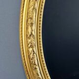 Miroir ovale doré style Louis XVI, XIXe siècle