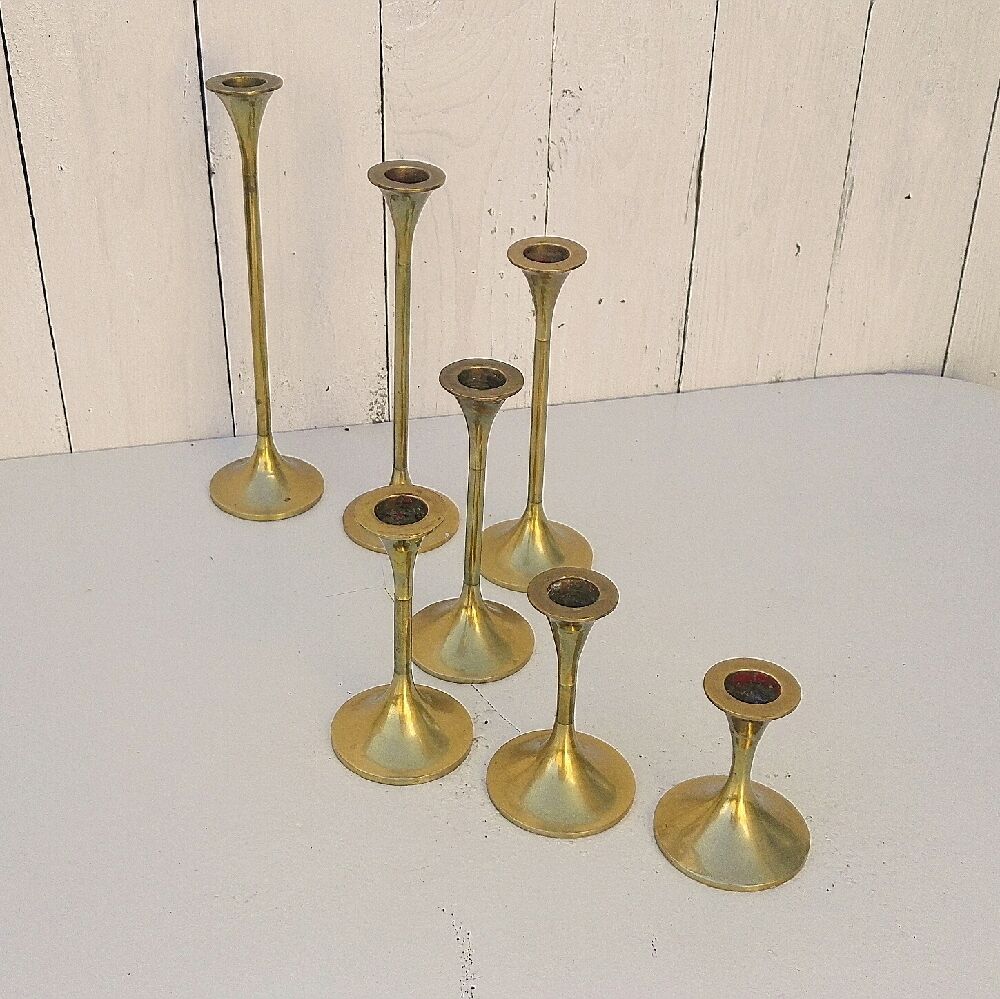 Seven candle holders in golden brass vintage trend