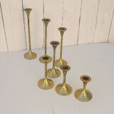 Seven candle holders in golden brass vintage trend