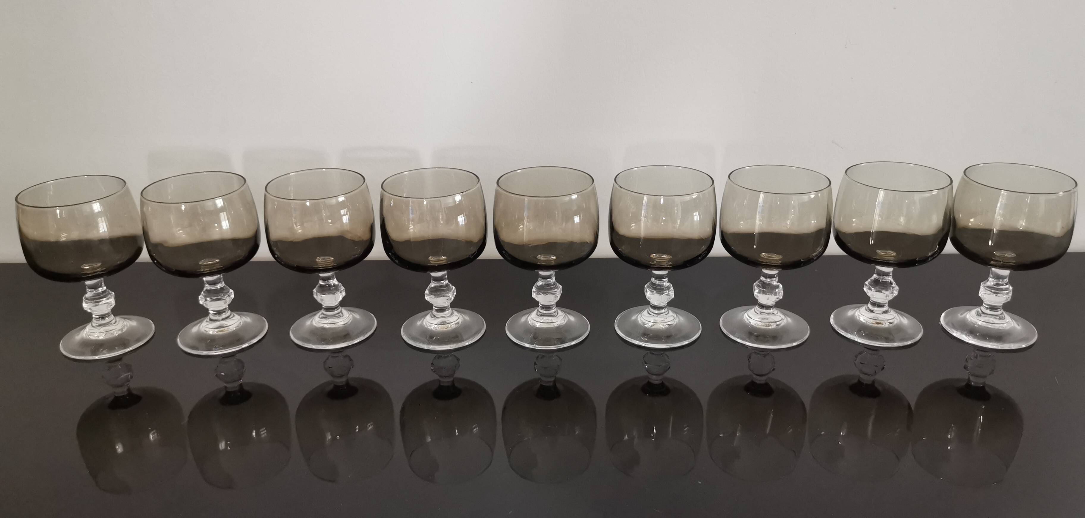 9 white wine glasses on vintage Luminarc smoked black stem