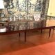 Directoire period extendable dining table in mahogany with a band.