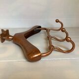 Wall mounted coat rack in the shape of a hanger