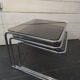 Nesting tables in chromed metal with smoked glass tops from the 1970s