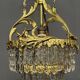 Antique chandelier in gilded bronze with crystal pendants.