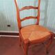 Table extensible et 4 chaises paillées, en merisier