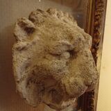Antique gilded frame with stone lion head ornament on plexiglass