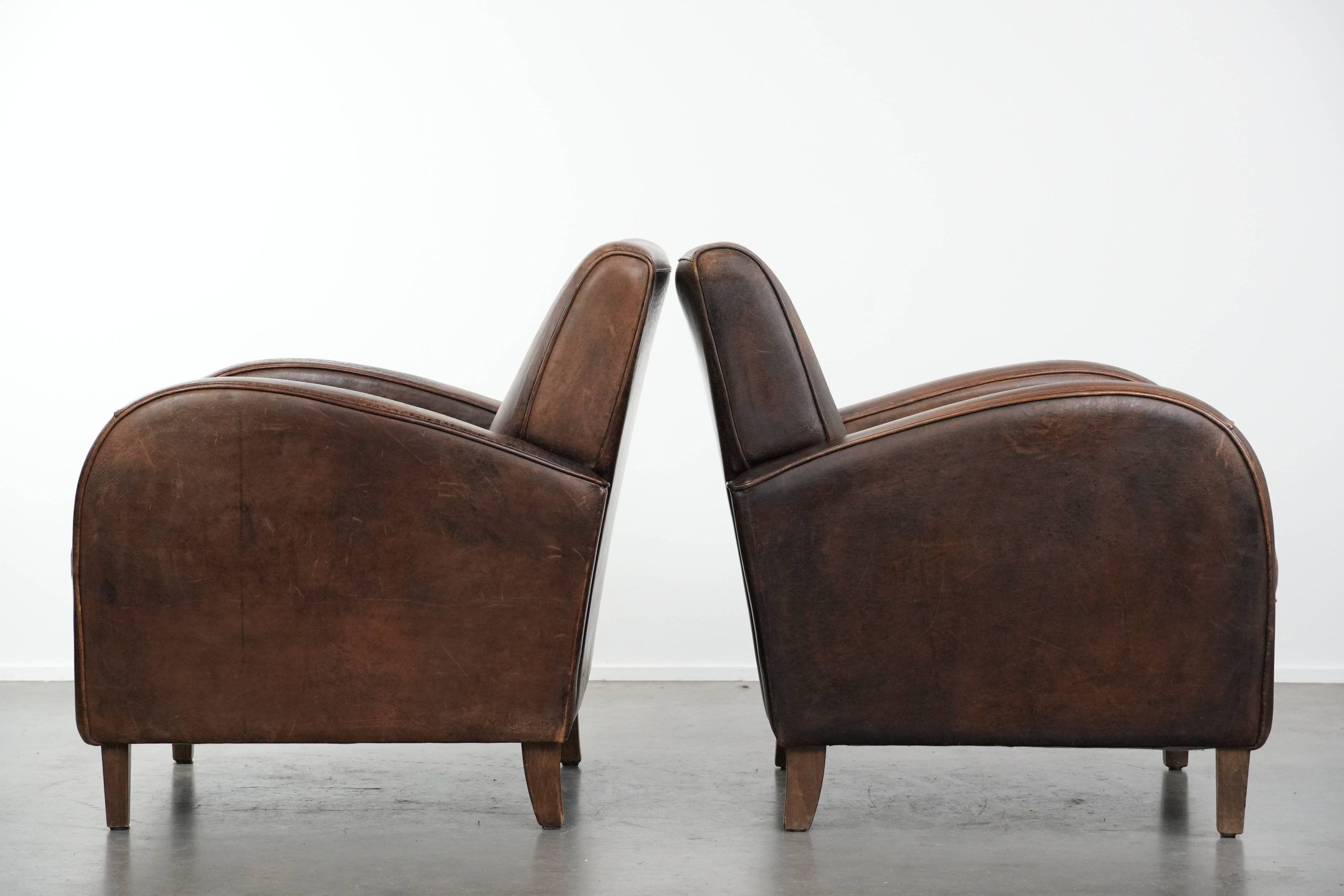 Set of two vintage sheepskin leather design armchairs in a cognac colour