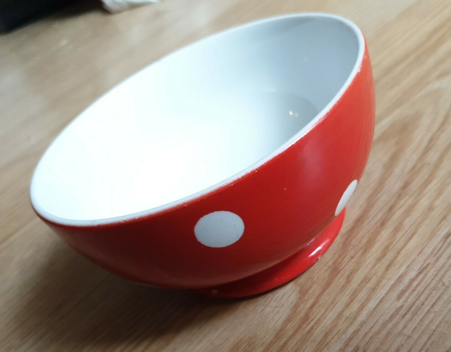 Red bowl with white polka dots signed Longchamp Porcelaine France