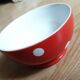 Red bowl with white polka dots signed Longchamp Porcelaine France