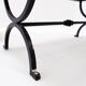 Set of 2 solid wood benches with an openwork design and wrought iron legs.