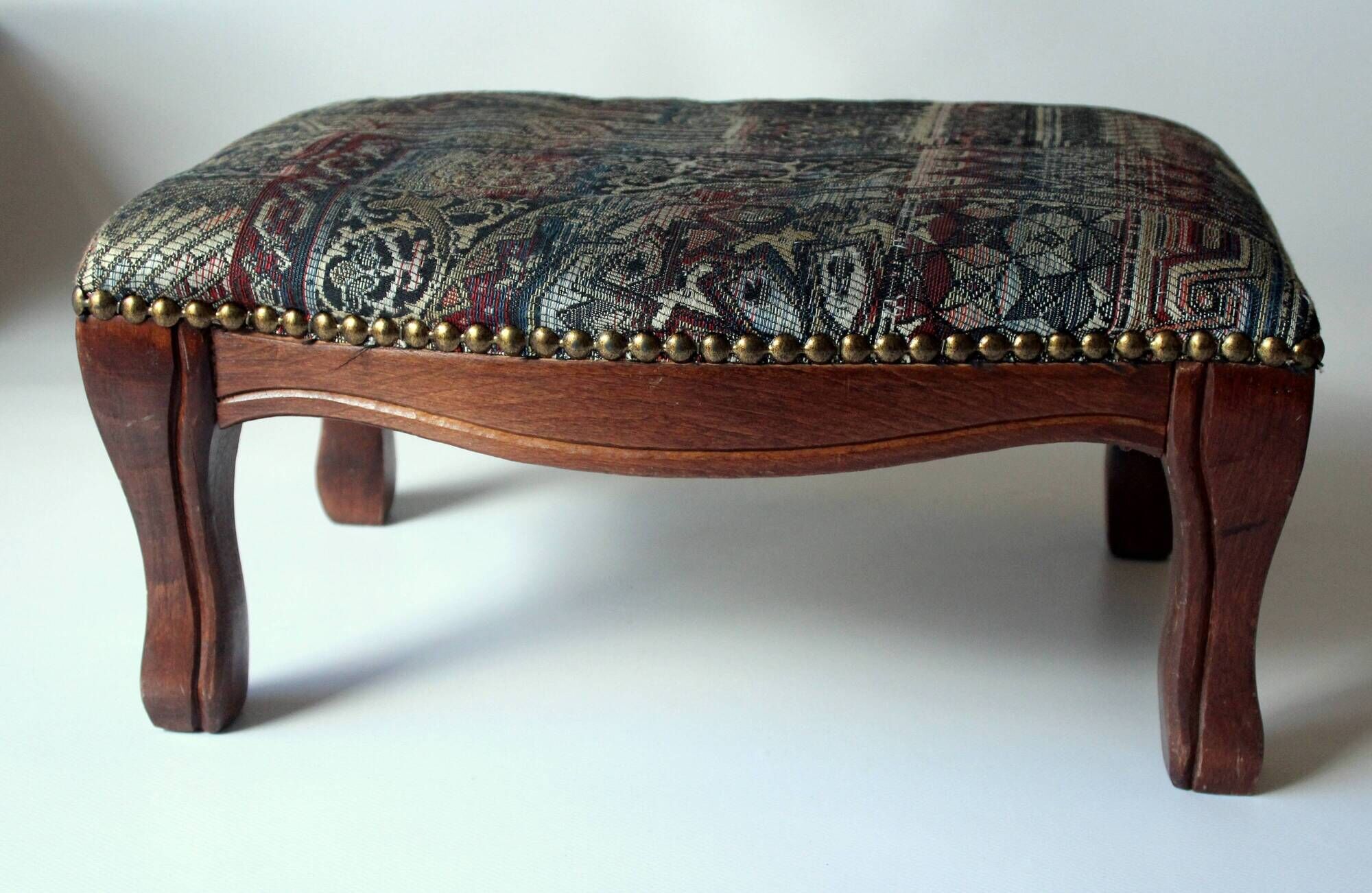 Small foot stool made of wood with upholstery, vintage from the 70s