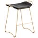 Pair of backless stools, black with brass trim.