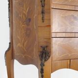 Baroque style wooden chest of drawers with bronze frieze.