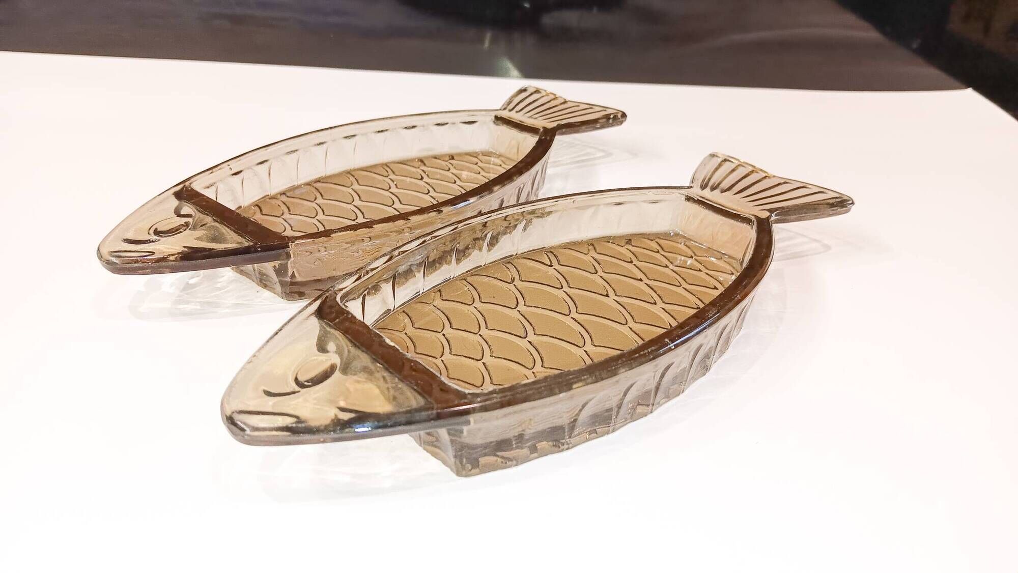 Set of 2 transparent smoked glass bowls in the shape of a fish.