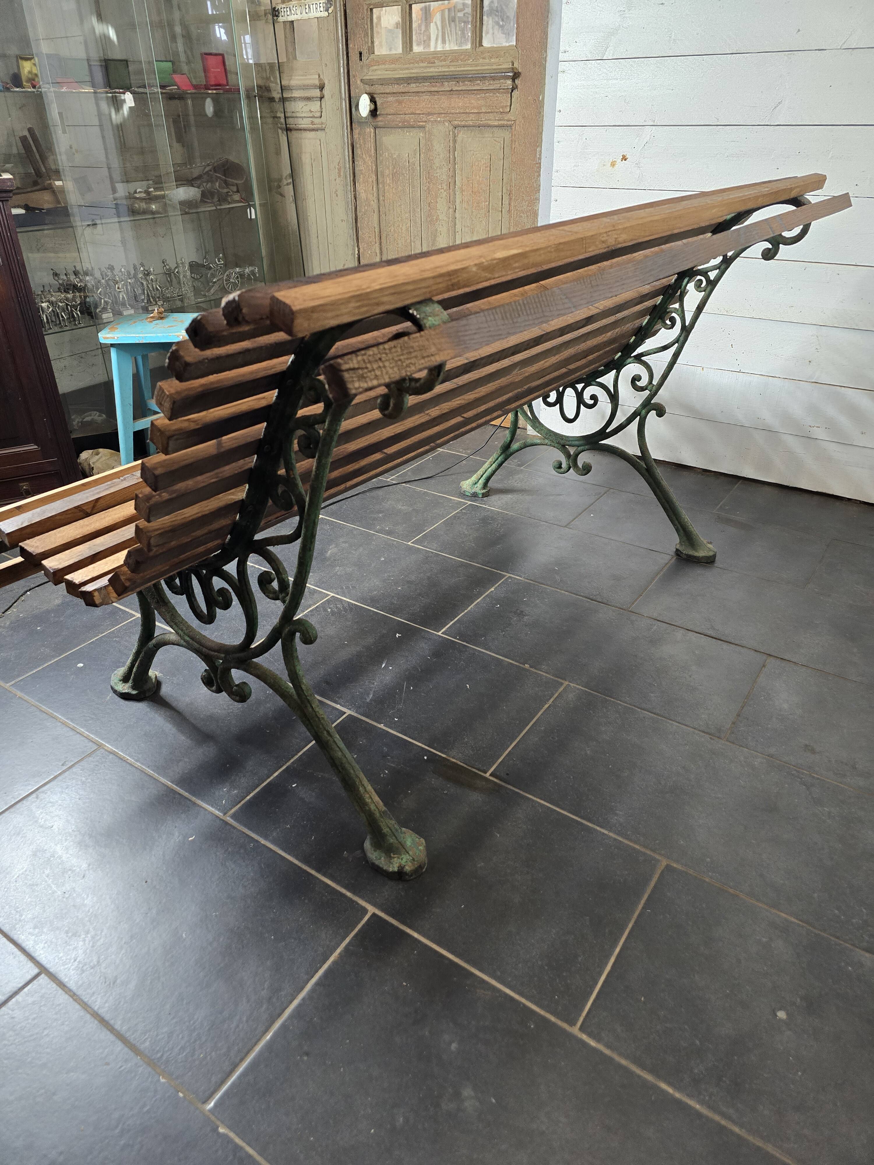Old cast iron garden bench with oak slats