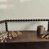 Natural wood chest forming a bench, ringed shoulders