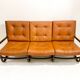 Mid-century modern rattan and cognac leather sofa
