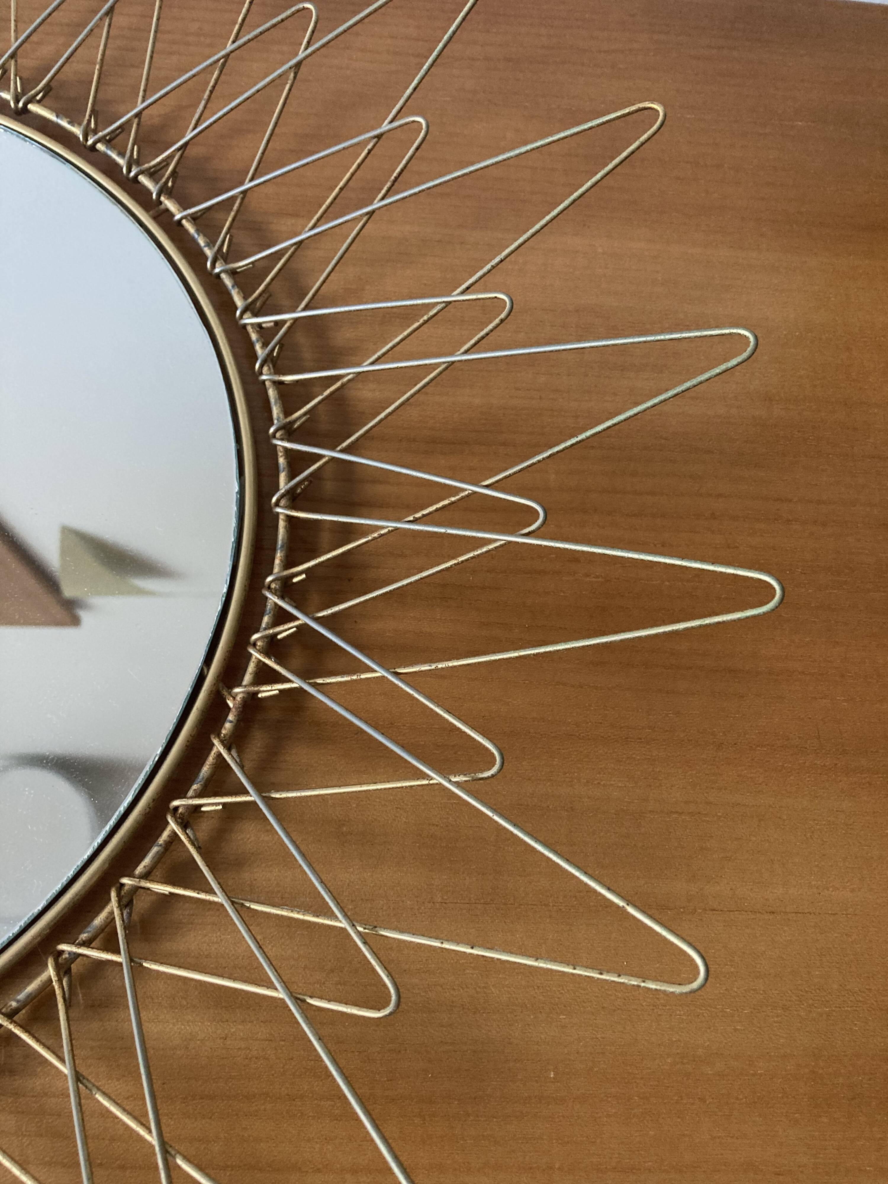 Sun mirror in gilded metal