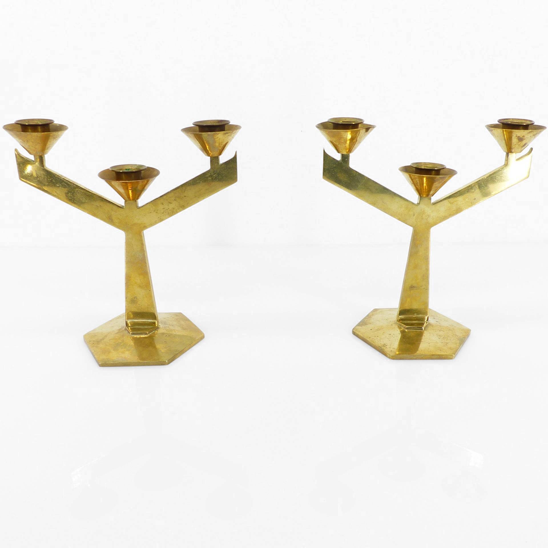 Pair of modernist three-armed solid brass candlesticks, circa 1960