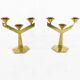 Pair of modernist three-armed solid brass candlesticks, circa 1960