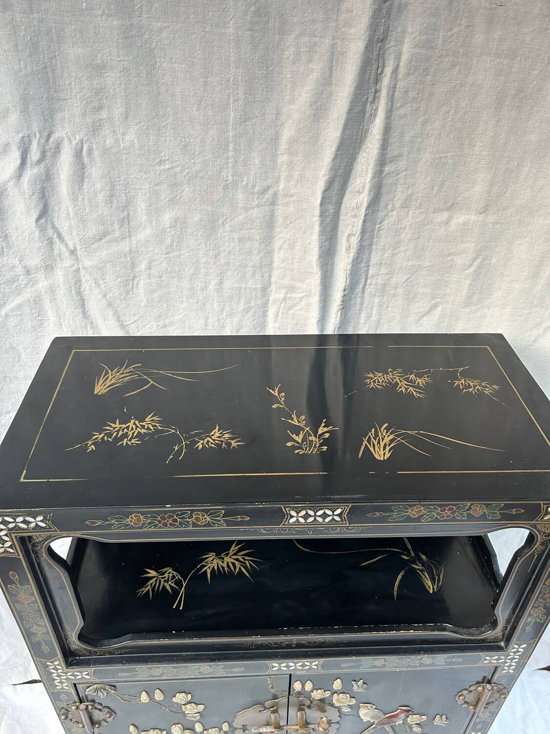 Chinese sideboard with gold lacquer and mother-of-pearl inlay. Bird and landscape decor.