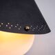Matte black wall lamps with perforated shades and brass details