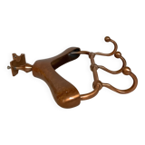 Wall mounted coat rack in the shape of a hanger
